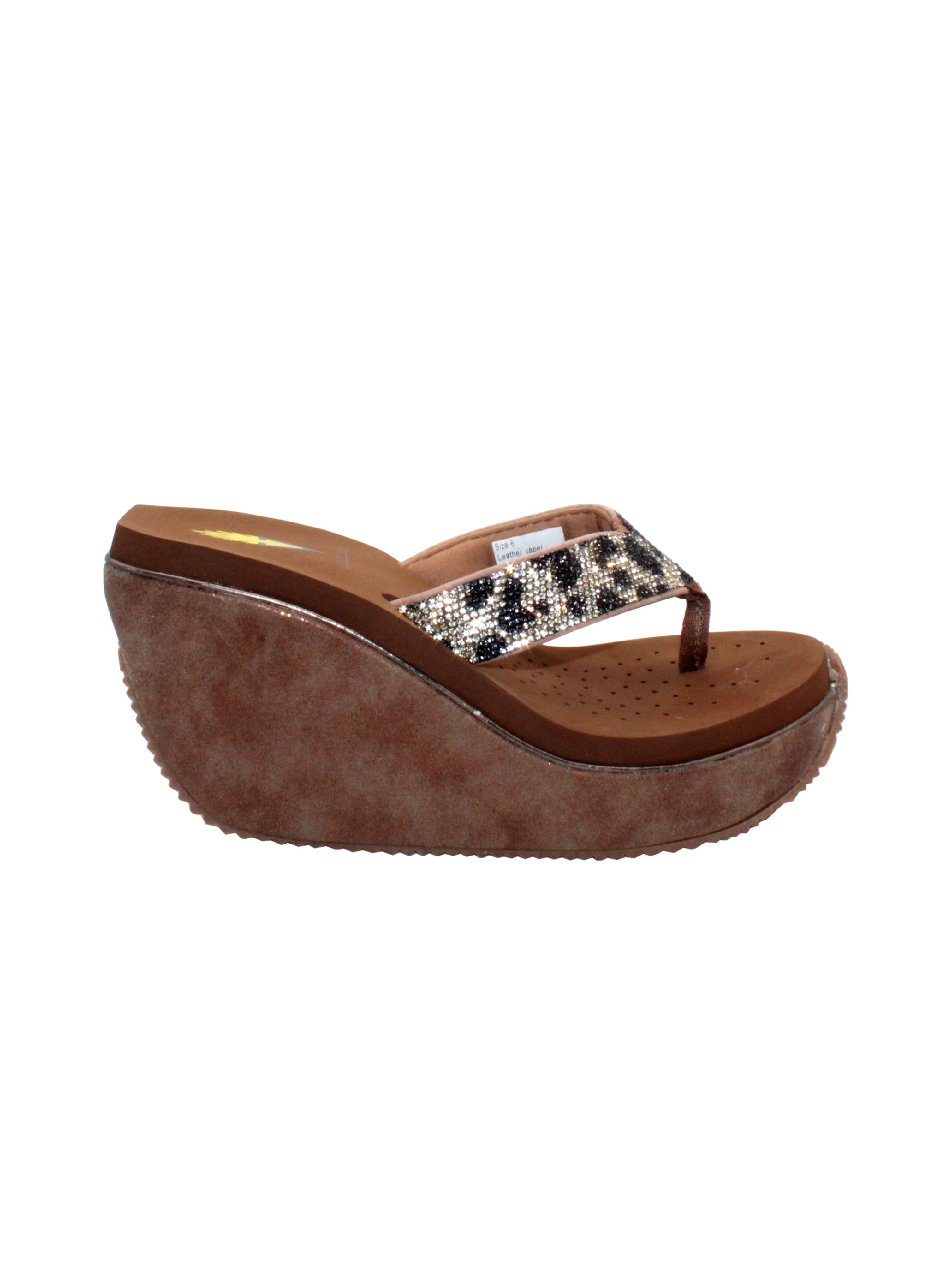 Volatile’s Glimpse platform wedge sandal’s leather upper straps are embellished with sparkling rhinestones. The classic thong style has a soft fabric post that rests gently between your toes, and the signature ultra-comfort EVA insole provides all day comfort. Perfect for special occasions, they’ll complement everything from dresses to jeans. tan multi